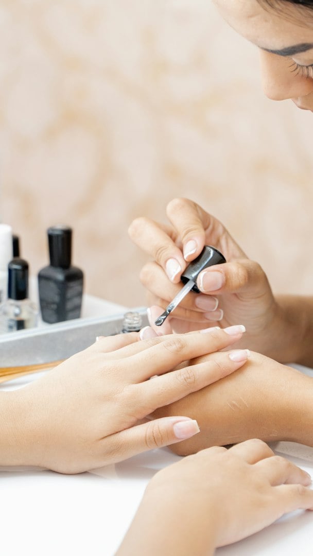 Happy women making nail beauty treatments